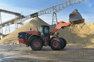 wheel loader loading gravel onto a truck